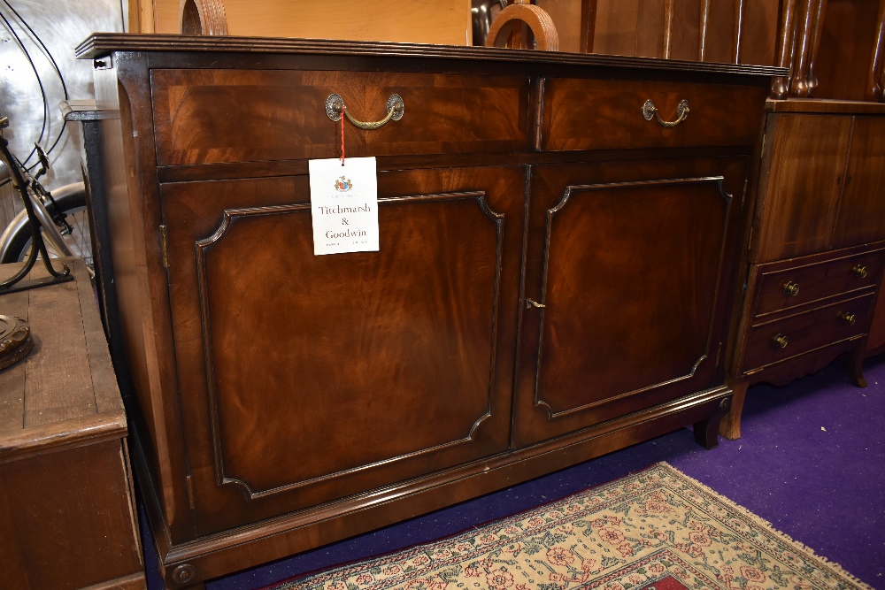 A reproduction mahogany sideboard, label for Titchmarsh and Goodwin, in the Regency style, width