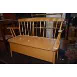 A beech and ply box seat of small proportions (childrens size) having spindle back, width approx.
