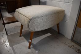 A vintage footstool, upholstered seat on splay legs