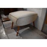 A vintage footstool, upholstered seat on splay legs