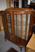 An art deco cocktail or display cabinet having mahogany veneer body