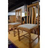 A pair of stripped dining chairs