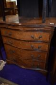 A reproduction serpentine chest of drawers (four plus brushing slide), width approx. 70cm