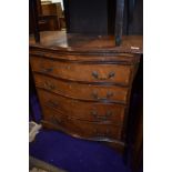 A reproduction serpentine chest of drawers (four plus brushing slide), width approx. 70cm