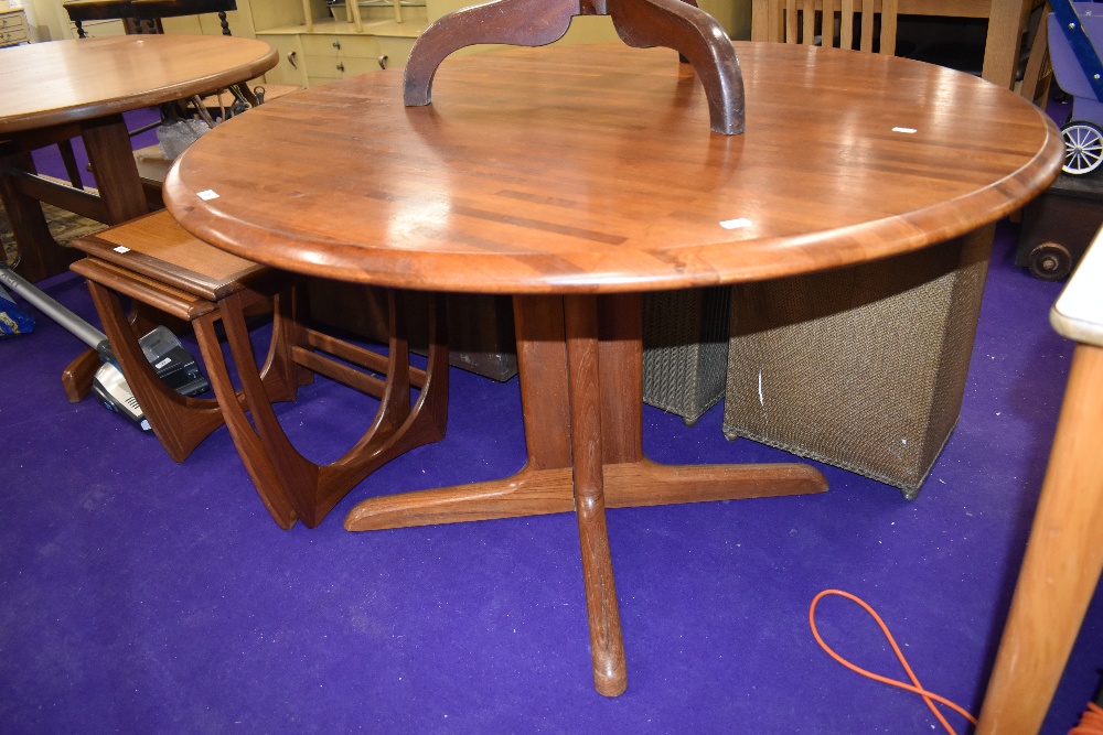 A vintage teak circular dining table on shaped legs, top in a parquet style, diameter approx. 120cm