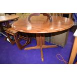 A vintage teak circular dining table on shaped legs, top in a parquet style, diameter approx. 120cm