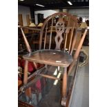 A childs low rocking arm chair in dark stain by Ercol having blue badge