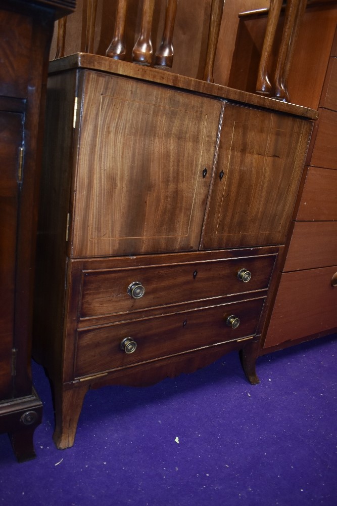 A reproduction Regency style TV cabinet, small proportions, would possibly work as a drinks cabinet