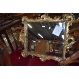 A Chippendale style period mirror with elaborately carved gilt and gesso frame with silver backed