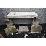 A garden bench having sand stone uprights with RAF military headstone as seat and similar carved