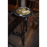 A traditional brass sundial on wrought iron stand
