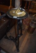 A traditional brass sundial on wrought iron stand