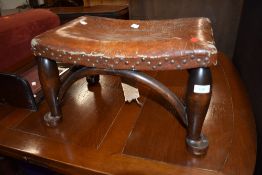 A vintage leather topped footstool