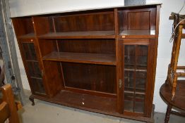 An early 20th Century mahogany bookcase, with narrow glazed display sections to each side, width