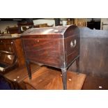 A Regency mahogany and inlaid dome top cellarette, having brass handles and tapered legs, no