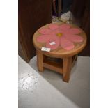 A traidtional stool with painted flower decoration