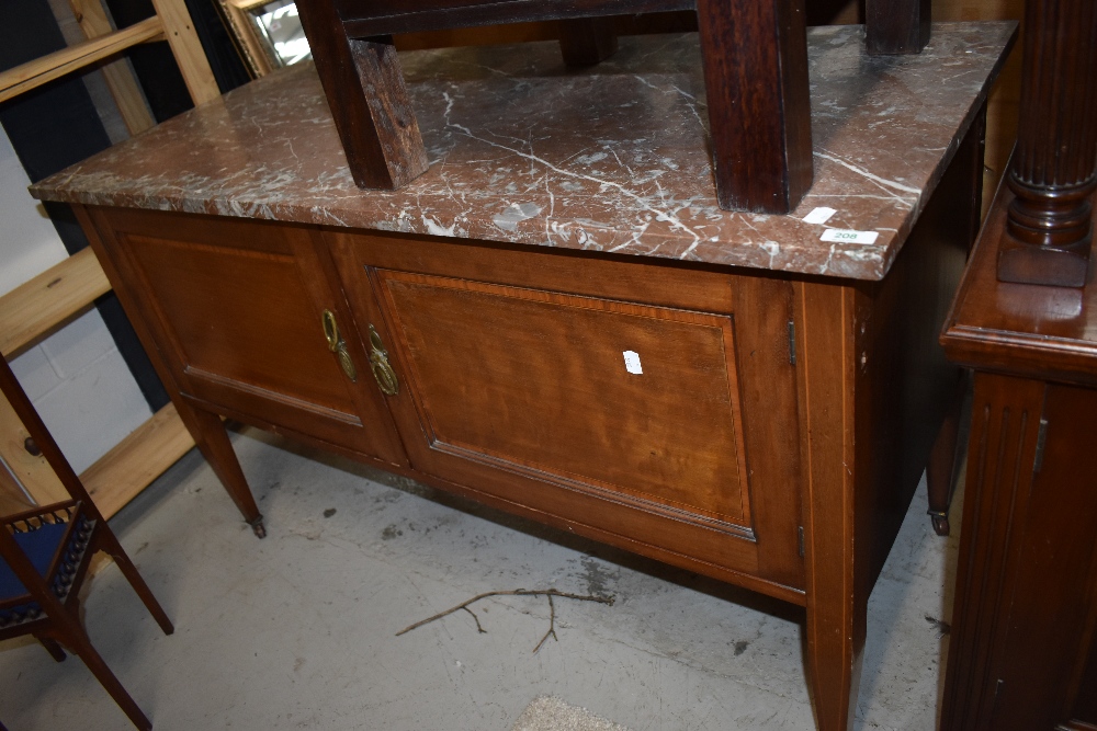 A Victorian wash stand having double under cupboard with pink marble top and mahogany frame with