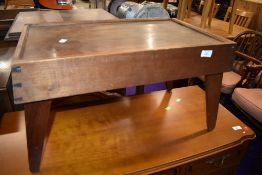 An early 20th Century craftsman made oak bed style table, having exposed joints and carry handles