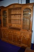 A natural pine kitchen dresser having glazed display top, width approx. 183cm