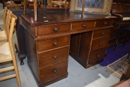 An early 20th Century stained frame pedestal desk