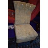 A vintage nursing chair with moquette style upholstery on stained frame