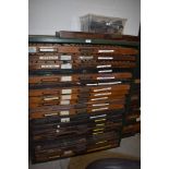 An industrial printers type set drawer unit with 19 letterpress drawers of various ages all with