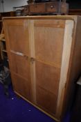 A vintage golden oak compact wardrobe, part fitted interior, height approx. 123cm, width 84cm