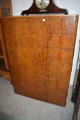 A 1930s figured walnut tallboy having phenolic style handles and fitments