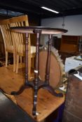 A late 19th/early 20th Century circular occasional table, on four turned columns and splay legs,