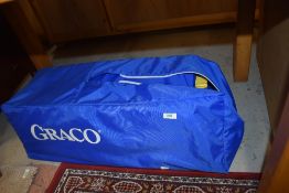 A Graco travel cot