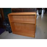 A vintage light beech bookcase, labelled for Herbert Ellis, width approx. 91cm