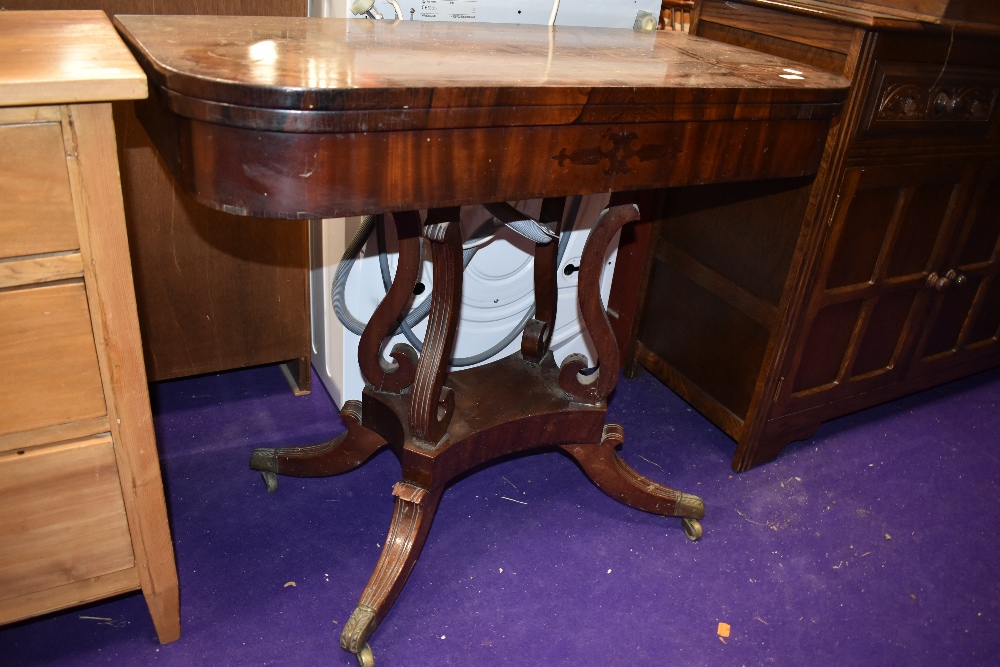 A 19th Century mahogany and inlaid fold over card table, complete but in need of some restoration