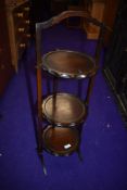 A reproduction mahogany folding cake stand