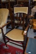 An art nouveau carvers dining chair having carved and inlayed detail
