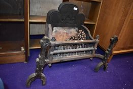 A cast iron fire dog grate