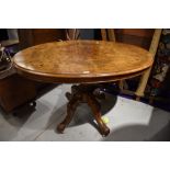 A 19th Century walnut and inlaid oval snap top pedestal table on turned column and quadruple foliate