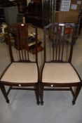 A pair of Edwardian mahogany and inlaid dining or bedroom chairs, having spade feet