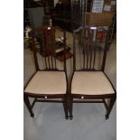 A pair of Edwardian mahogany and inlaid dining or bedroom chairs, having spade feet