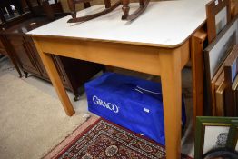 A 1950's utility/kitchen table having formica top with pine frame, stamped Remply