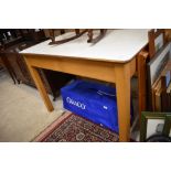 A 1950's utility/kitchen table having formica top with pine frame, stamped Remply