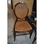 A Victorian bed room or salon chair having balloon back and woven fibre seat