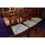 A set of three early 20th Century stained frame rail back dining chairs