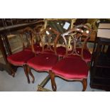 A set of six late 18th century mahogany framed dining chairs having carved backs on cabriole legs