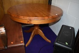 A modern pine circular extending dining table