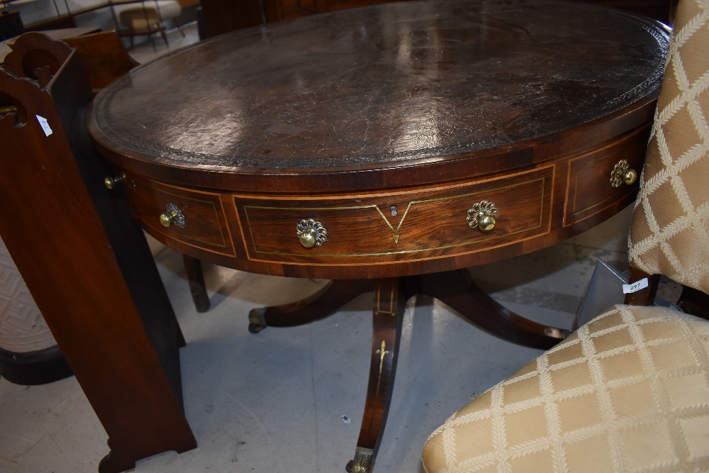 A 19th Century Regency and later mahogany drum table with leather skiver top, brass handles,