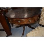 A 19th Century Regency and later mahogany drum table with leather skiver top, brass handles,