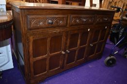 A vintage Priory/Old Charm style oak and ply sideboard, width approx. 133cm