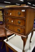 A Reprodux reproduction bedside chest of three drawers on stand