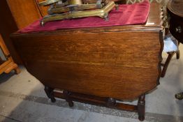 A late Victorian oak kitchen table having pie crust top table with barley twist legs