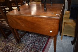 A late 19th or early 20th Century mahogany Pembroke table having frieze drawer on tapered legs and